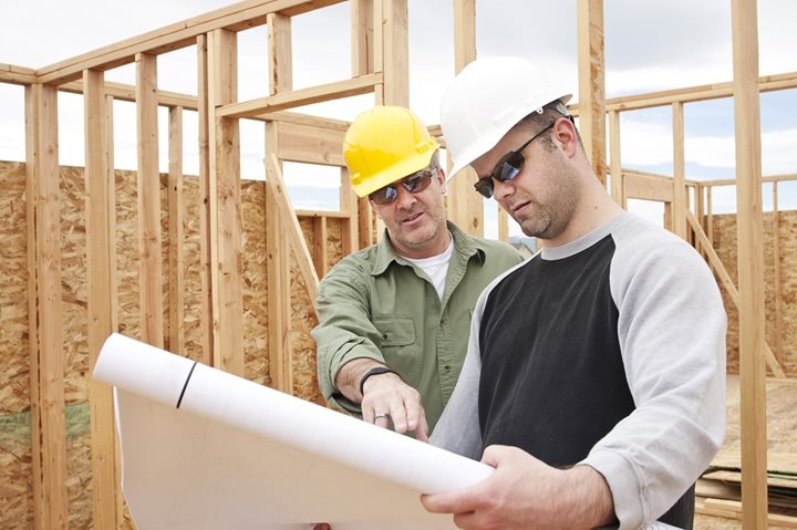 Home builders reviewing blueprint