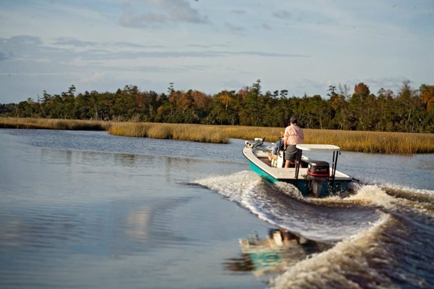 fishing boat in water with wake