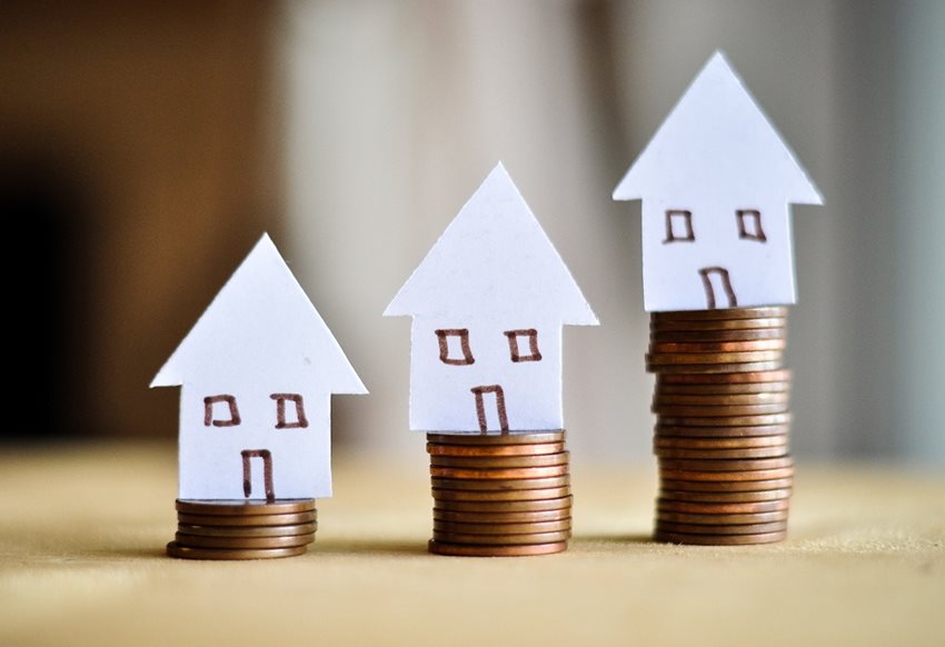 Stacks of Pennies with Paper Houses